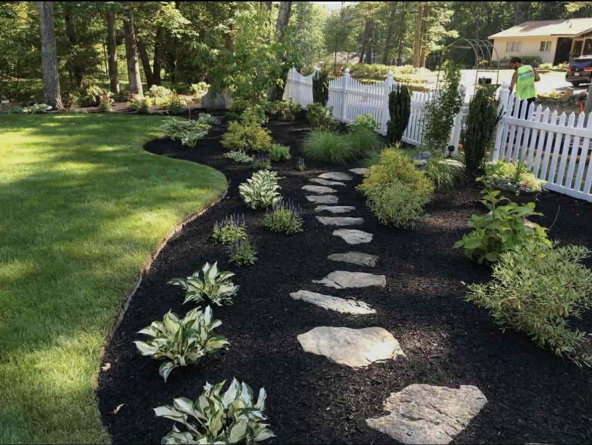 Stone walkway and planted beds installed by crjlandscaping.com